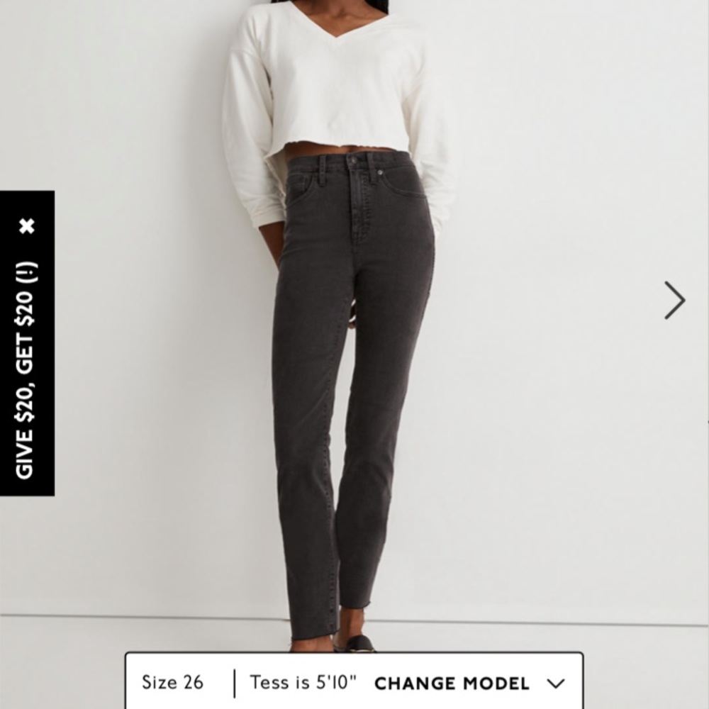 11" High-Rise Skinny Jeans in a black with distressed hem.
